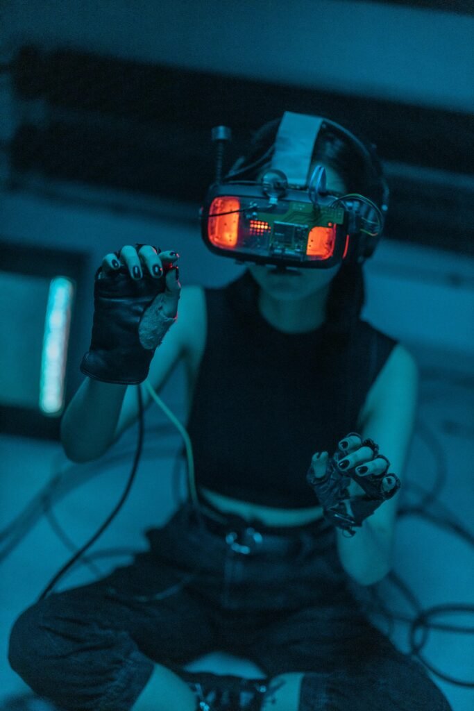 Woman in a dark room using a VR headset, showcasing technology and immersion.